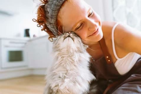 Woman embracing her cat, reflecting the calm tone of the Autistic Innovations website